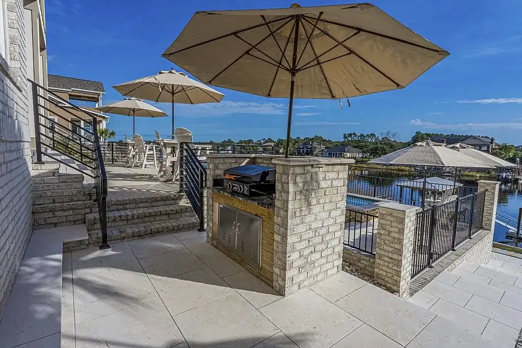 Lux Project 10 custom outdoor kitchen with umbrella beside pool